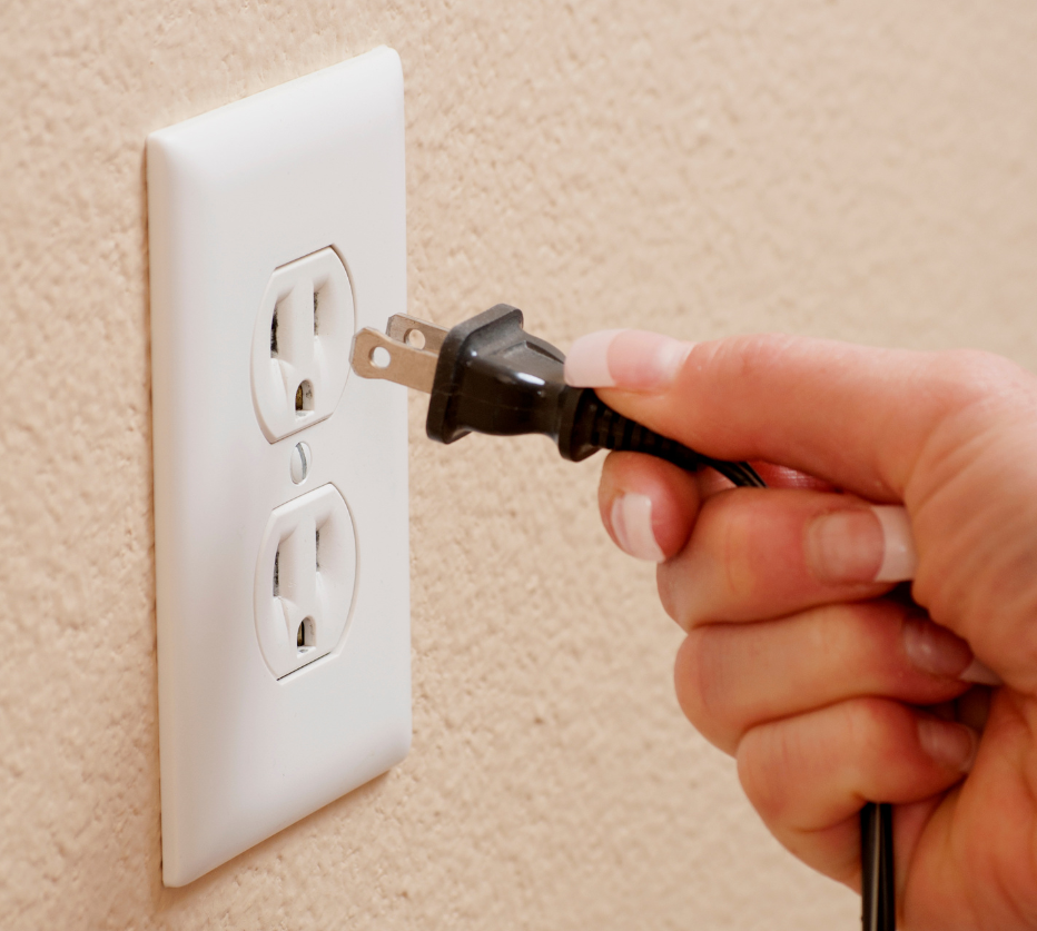 a person plugging a cable in the board